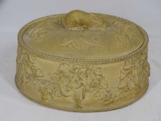 STONEWARE GAME PIE DISH in the style of Wedgwood, the lid with rabbit finial and further game in