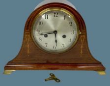 ANTIQUE MAHOGANY PENDULUM DRIVEN MANTEL CLOCK - with garland inlay and on brass bracket feet,