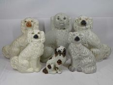 STAFFORDSHIRE POTTERY DOGS, six individual of various sized seated spaniels, 34cms H the tallest,