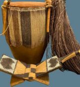 AFRICAN ANIMAL SKIN BONGO DRUM, folding seat and a grass skirt, 48cms H the drum, 56cms across the