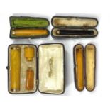 9CT GOLD, GILT METAL & OTHER AMBER CHEROOT HOLDERS (4), the two smaller having 9ct gold stamped