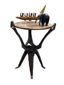 AFRICAN CARVED HARDWOOD FOLDING TABLE, ebony elephant and a South Seas type model of a boat