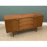 MID-CENTURY TEAK TYPE SIDEBOARD BY 'AUSTIN SUITE' - three central drawers flanked by cupboard doors,
