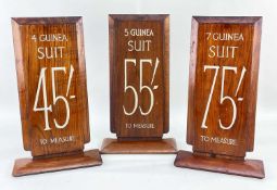 THREE VINTAGE WALNUT TAILOR'S SIGNS, for suits priced 4, 5 and 7 guineas and measuring costs in