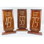 THREE VINTAGE WALNUT TAILOR'S SIGNS, for suits priced 4, 5 and 7 guineas and measuring costs in