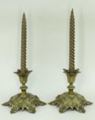 PAIR VICTORIAN GOTHIC BRASS CANDLESTICKS, the foliate sconces above short waisted necks on raised