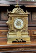 LATE 19TH CENTURY FRENCH GILT BRASS MANTEL CLOCK, case with domed top and square section with mask