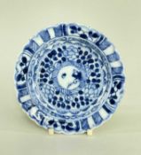 CHINESE BLUE & WHITE SAUCER, Kangxi, painted with a boy in a roundel within leaves and diaper bands,