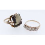 TWO GOLD RINGS comprising yellow metal five stone ring set with five white gem stones and