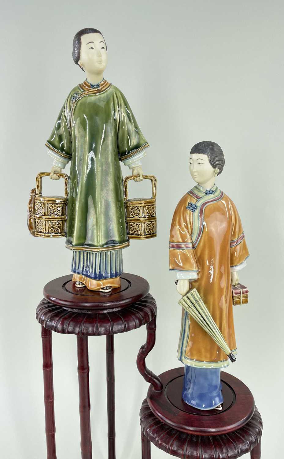 PAIR OF MODERN CHINESE STONEWARE FIGURES OF LADIES, in country outfits, one holding lunch baskets,