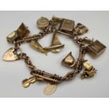 9CT GOLD CHARM BRACELET, having trombone links, heart shaped padlock, having various mainly 9ct gold