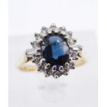 18CT GOLD SAPPHIRE & DIAMOND CLUSTER RING, the central sapphire (7 x 6mms) surrounded by fourteen