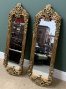 PAIR OF ANTIQUE GILT FRAMED MIRRORS, ornately decorated, oblong, 146cms H, 44cms W, 6cms D