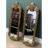 PAIR OF ANTIQUE GILT FRAMED MIRRORS, ornately decorated, oblong, 146cms H, 44cms W, 6cms D