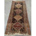 EASTERN CARPET RUNNER, multi-coloured with repeating central diamond pattern, multi bordered edge