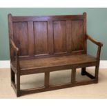 PERIOD OAK OPEN ARM BENCH having a four fielded panel back and an open base, previously on display