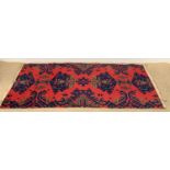 VINTAGE WOOLLEN RUG, red and blue with central repeating pattern, 92 x 192cms