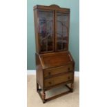 POLISHED OAK BUREAU BOOKCASE, the upper section with twin glazed doors having cloud effect