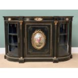 VICTORIAN EBONIZED CREDENZA with bowed twin glazed doors either side of Corinthian capped reeded