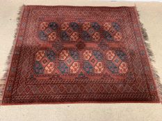 EASTERN RUG, red ground and multiple diamond pattern border, with tasselled ends, 174 x 139cms