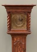 ANTIQUE OAK GRANDMOTHER CLOCK having a brass dial set with Roman numerals and single key aperture,