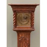 ANTIQUE OAK GRANDMOTHER CLOCK having a brass dial set with Roman numerals and single key aperture,