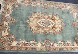 CHINESE WASHED RUG - ground green with tasselled ends. A fine example, 180 x 280cms