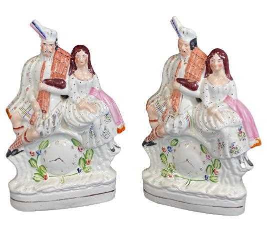 STAFFORDSHIRE POTTERY COUPLE FLATBACK FIGURINES (2) - with front clock detail, 35cms H