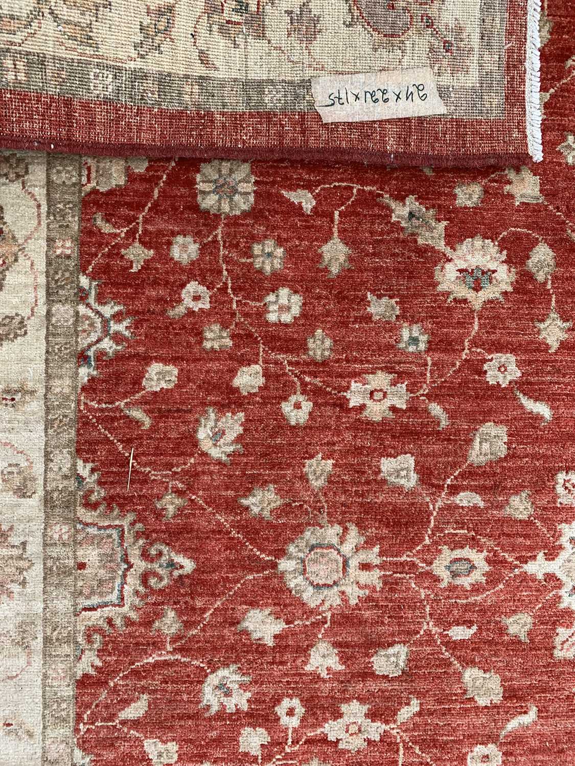 ANTIQUE EASTERN STYLE WOOLLEN RUG - red ground central section and a beige floral decorated - Image 2 of 2