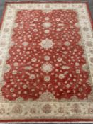 ANTIQUE EASTERN STYLE WOOLLEN RUG - red ground central section and a beige floral decorated