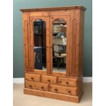 MODERN PINE WARDROBE, large example with twin glazed doors and three over two base drawers, 210cms
