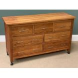 MODERN LIGHT WOOD MULTI- DRAWER CHEST on castors, 79cms H, 132cms W, 46cms D