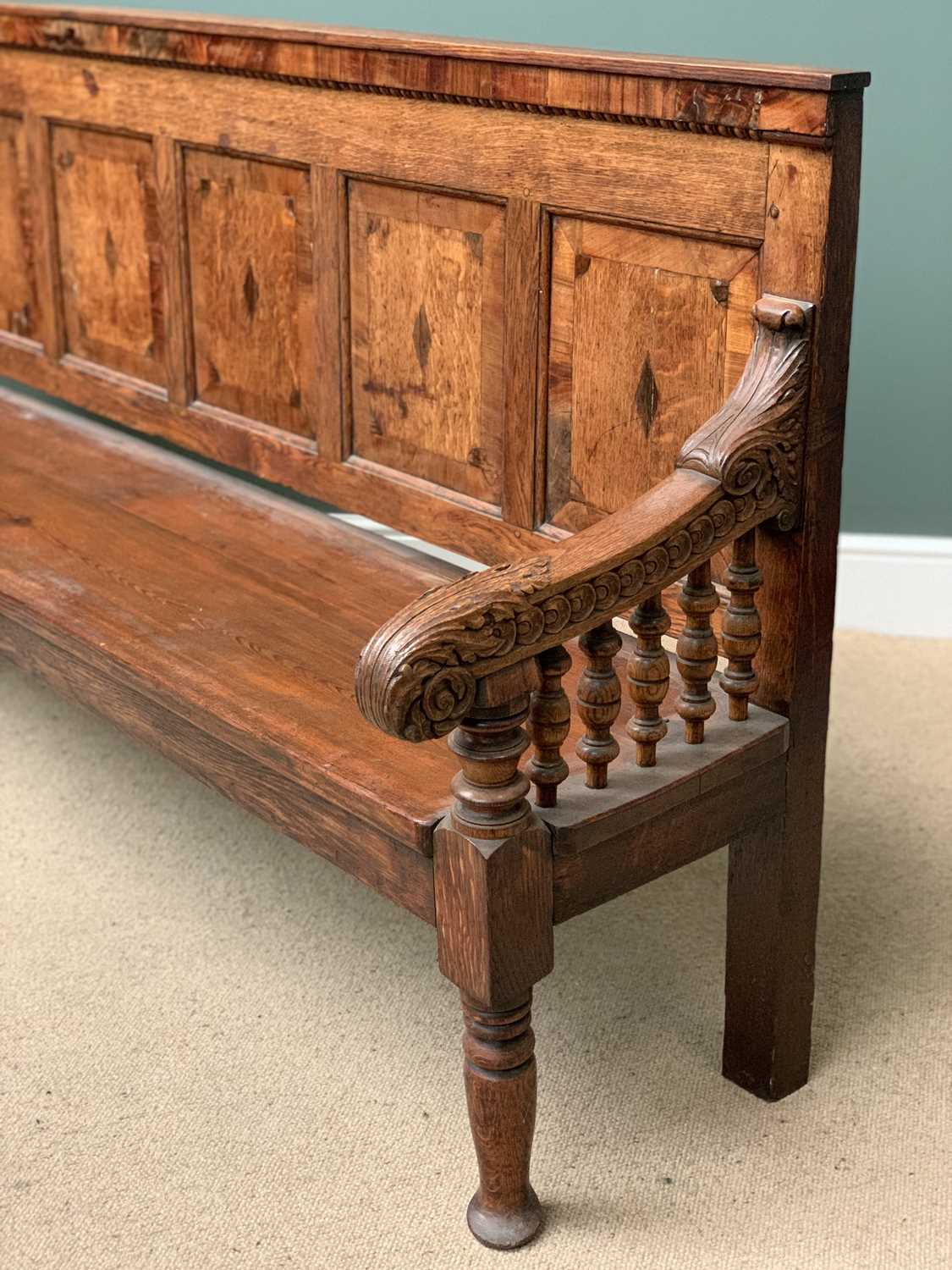 19th CENTURY OAK BENCH with a five fielded panel back, carved arms with bobbin supports, on turned - Image 4 of 5