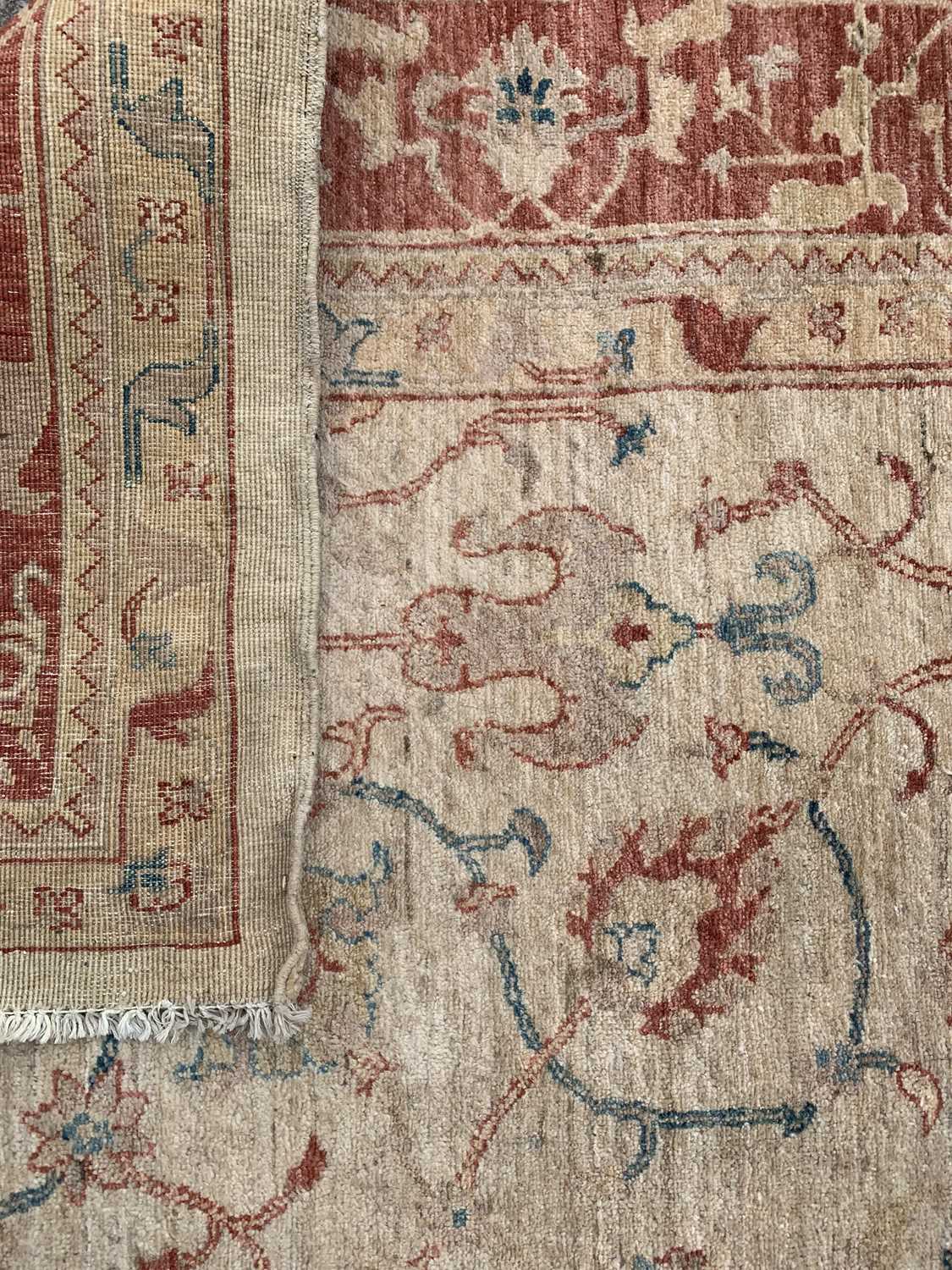 ANTIQUE EASTERN STYLE WOOLLEN RUG - cream ground with a red border and multi-patterned throughout, - Image 2 of 2