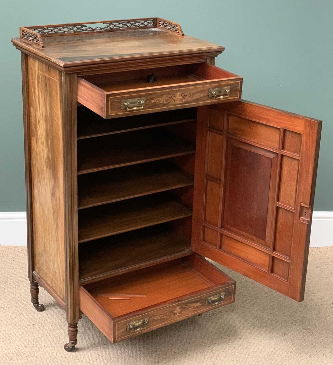 WALNUT MUSIC SHEET CABINET with fretwork gallery to the top and single door with bevelled glass