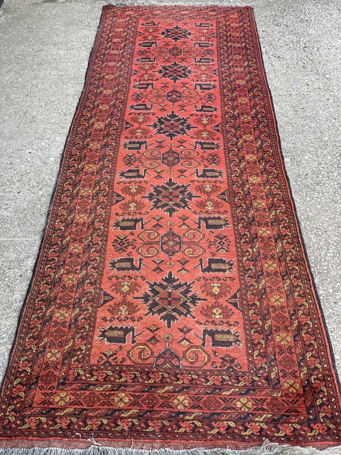 EASTERN CARPET RUNNER, red ground with multi-border and central diamond pattern, 202 x 83cms