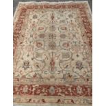 ANTIQUE EASTERN STYLE WOOLLEN RUG - cream ground with a red border and multi-patterned throughout,