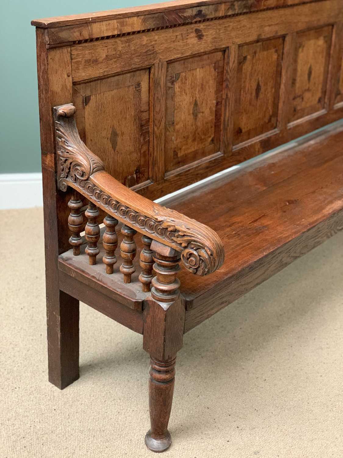 19th CENTURY OAK BENCH with a five fielded panel back, carved arms with bobbin supports, on turned - Image 5 of 5
