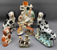 STAFFORDSHIRE POTTERY DOGS & FIGURINES - a collection to include a pair of black and white seated