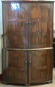 SUBSTANTIAL CORNER CUPBOARD - 18th Century oak, two piece, having a panelled bow front with two
