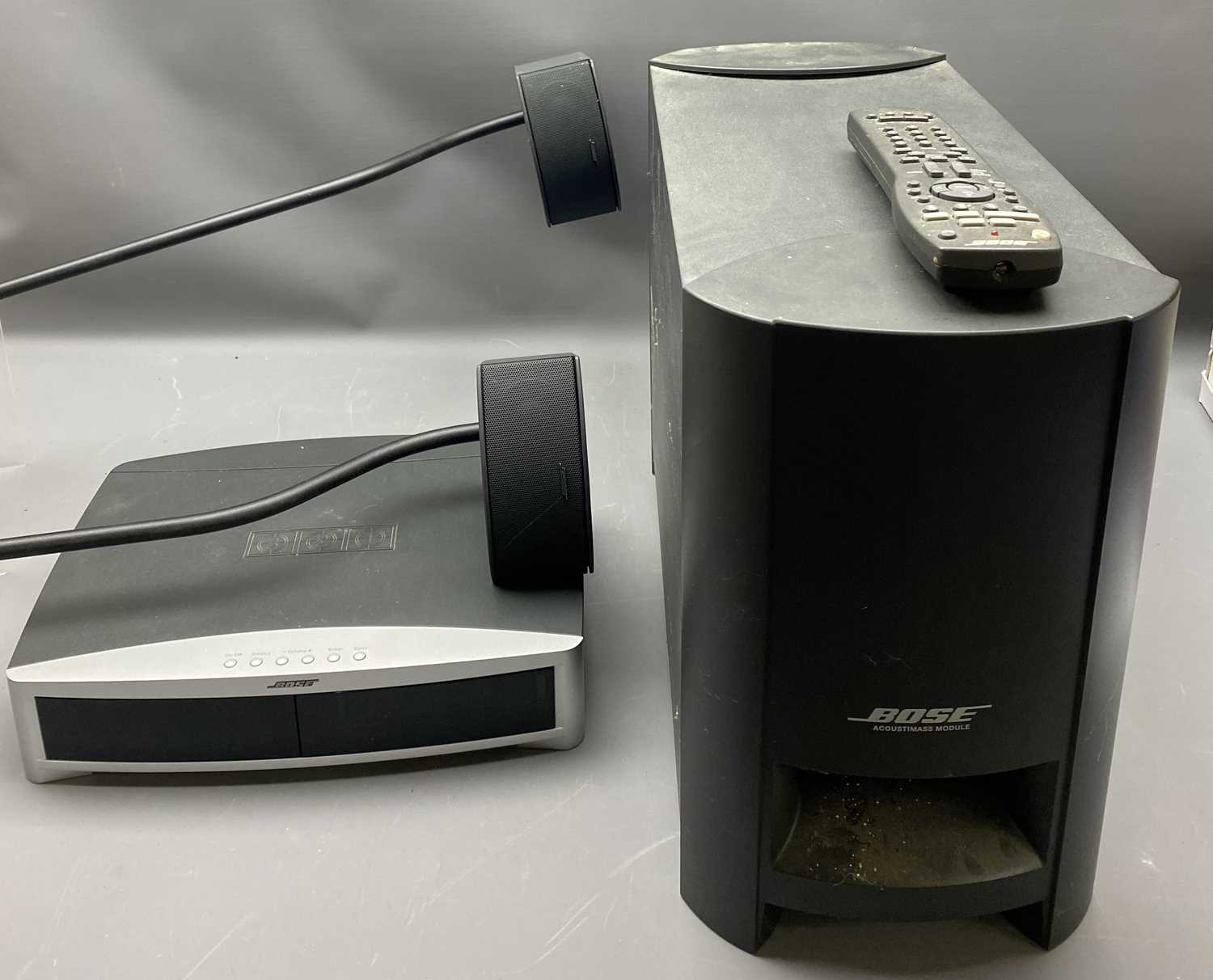 BOSE MODEL AV3-2-1-II MEDIA CENTRE, an acoustimass module and two small Bose speakers on stands