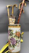 MODERN CHINESE POTTERY STICK STAND - containing a quantity of walking sticks and umbrellas, 46cms