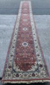 PERSIAN CARPET RUNNER, hand knotted, "Fine Indo Persian" wool with central red and floral pattern,