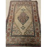 EASTERN RUG with multi-pattern border and diamond central motif, 190 x 130cms