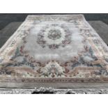 LARGE CHINESE WASHED WOOLEN RUG, with multi-border and floral pattern throughout, 280 x 395cms