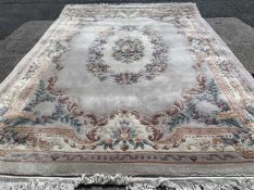 LARGE CHINESE WASHED WOOLEN RUG, with multi-border and floral pattern throughout, 280 x 395cms