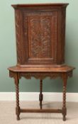 ANTIQUE CARVED OAK CORNER CUPBOARD on stand, with carved apron and bobbin supports, 166cms H,