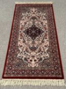 ROYAL KESHAN RUG - red ground with multi border and floral and diamond central motif, 83 x 160cms