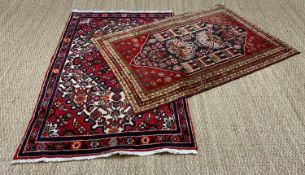 TWO SMALL ORIENTAL RUGS, both with central lozenge designed fields and multiple borders, one