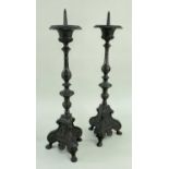 PAIR CONTINENTAL BAROQUE STYLE ALLOY PRICKET CANDLESTICKS, slender baluster stems on trefoil